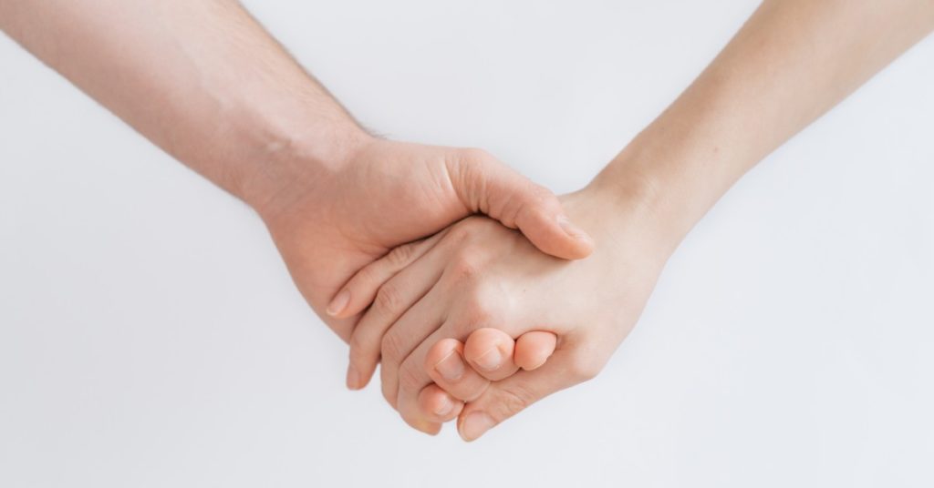 image of two hands holding each other