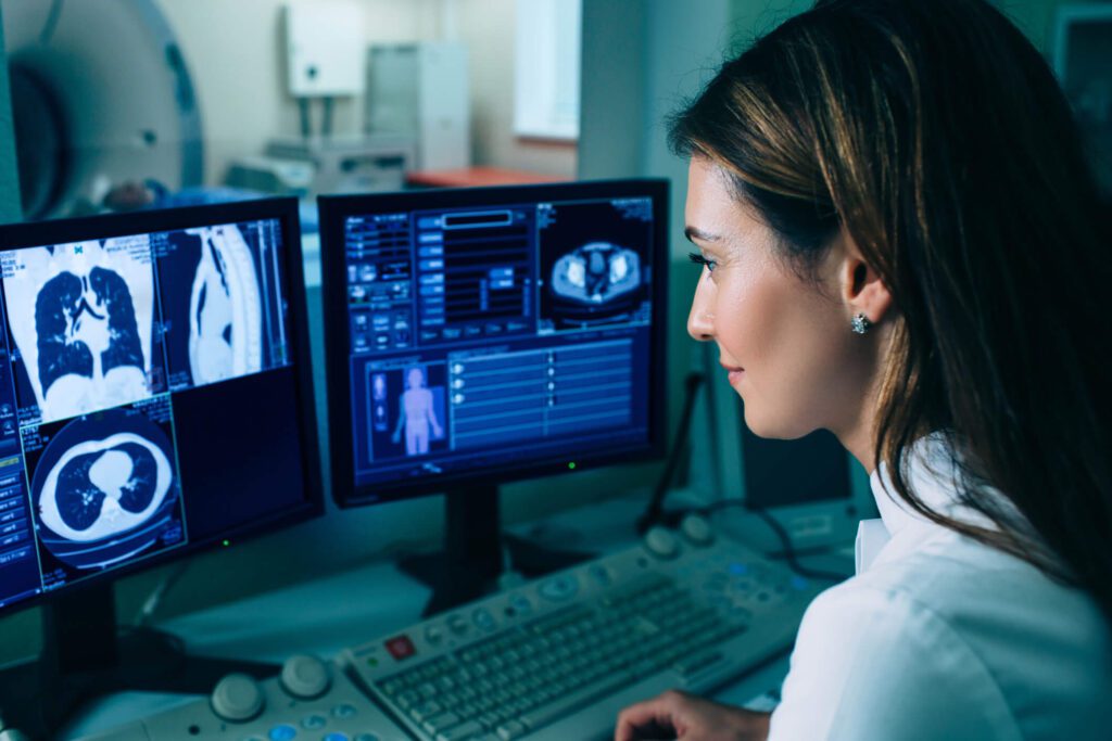 Female radiologist reading CT cardiac images