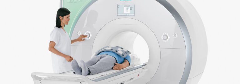 Radiology technologist scanning a patient in a PET scanner