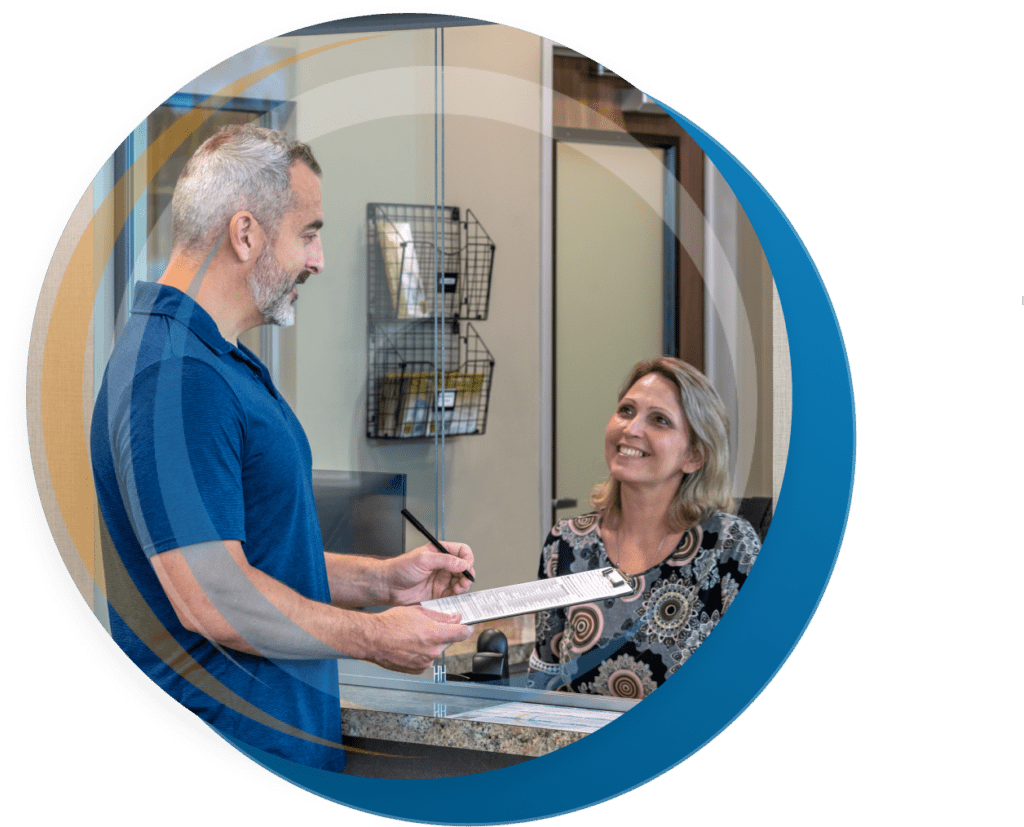 Patient checking at the front desk of a Touchstone Imaging center in Texas and speaking with a patient liaison