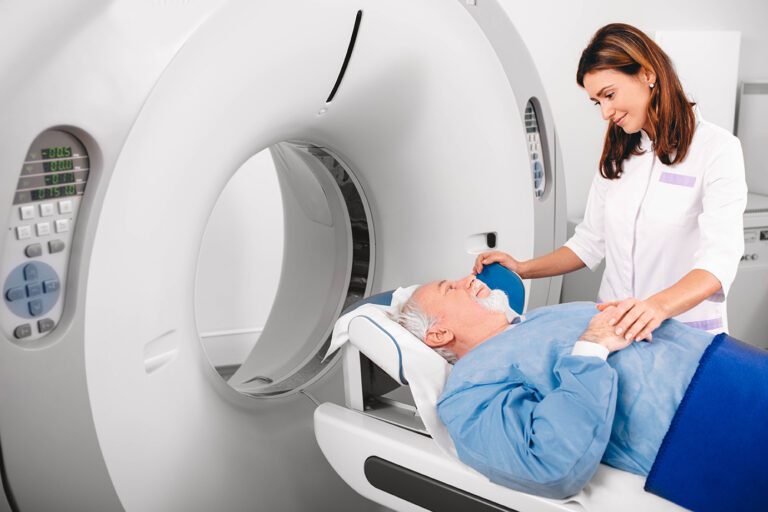 Radiology Technologist and Older Male Patient prepare for a head CT