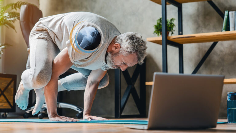 Older man doing yoga and needs a shoulder MRI to diagnose shoulder pain.