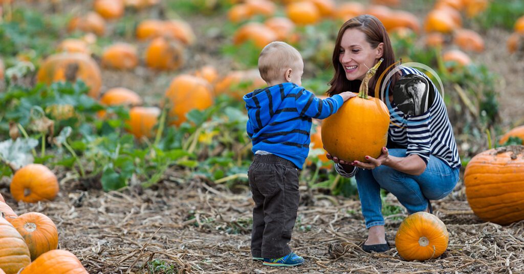 Woman with shoulder pain seen on an MRI picking pumpkins with a child
