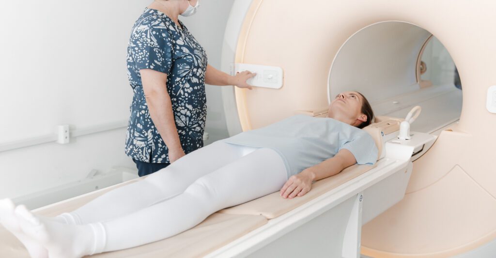 Technologist preparing patient for MRI scan.