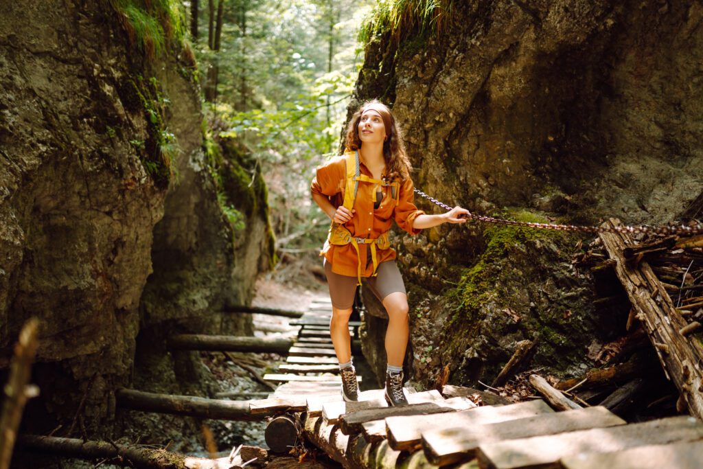Happy woman exploring hiking steps in nature.