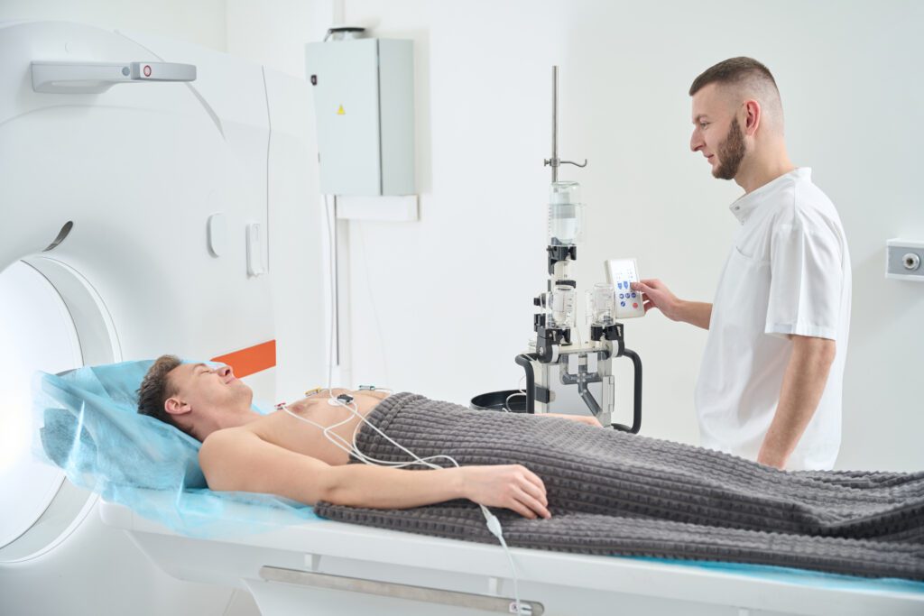 CT technologist preparing patient for CT Angiogram with contrast